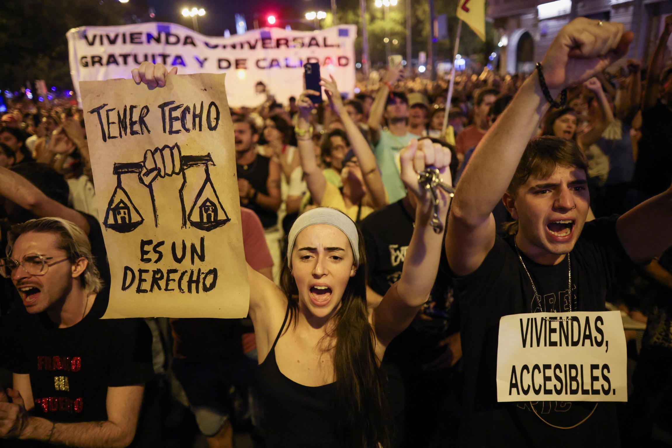 Demonstrators hold signs reading "Housing is a right" and "Affordable housing" during a protest against Spain's housing crisis after the forceful eviction of an 87-year-old woman from her apartment in Madrid, Spain, on September 26, 2026.