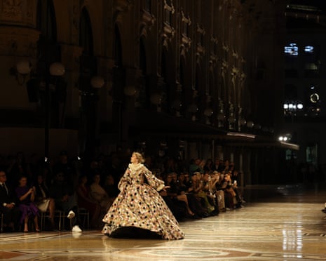 Gigi Hadid walks the runway in an elaborate patterned ballgown inside a grand historic gallery