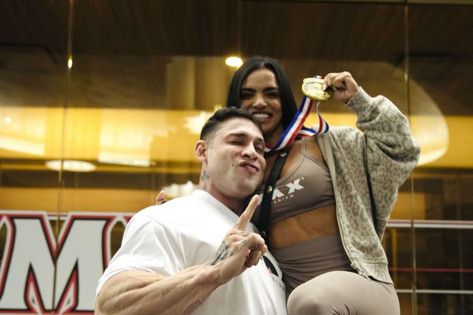Vit&oacute;ria e seu marido, Ramon Dino, seguram medalha de terceiro lugar