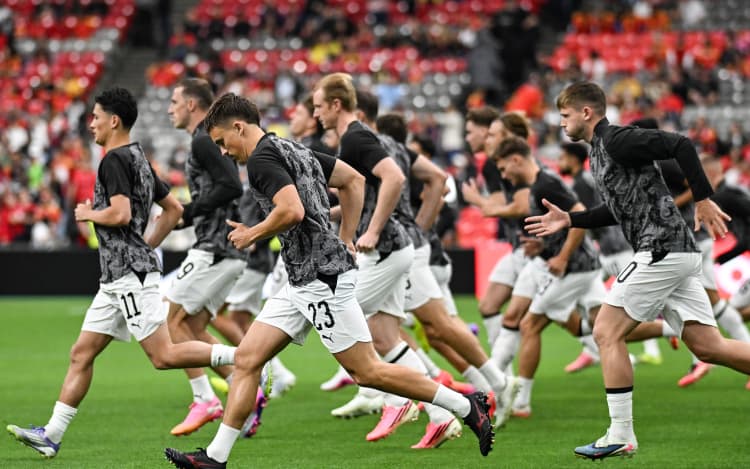 New Zealand All Whites players warm up.