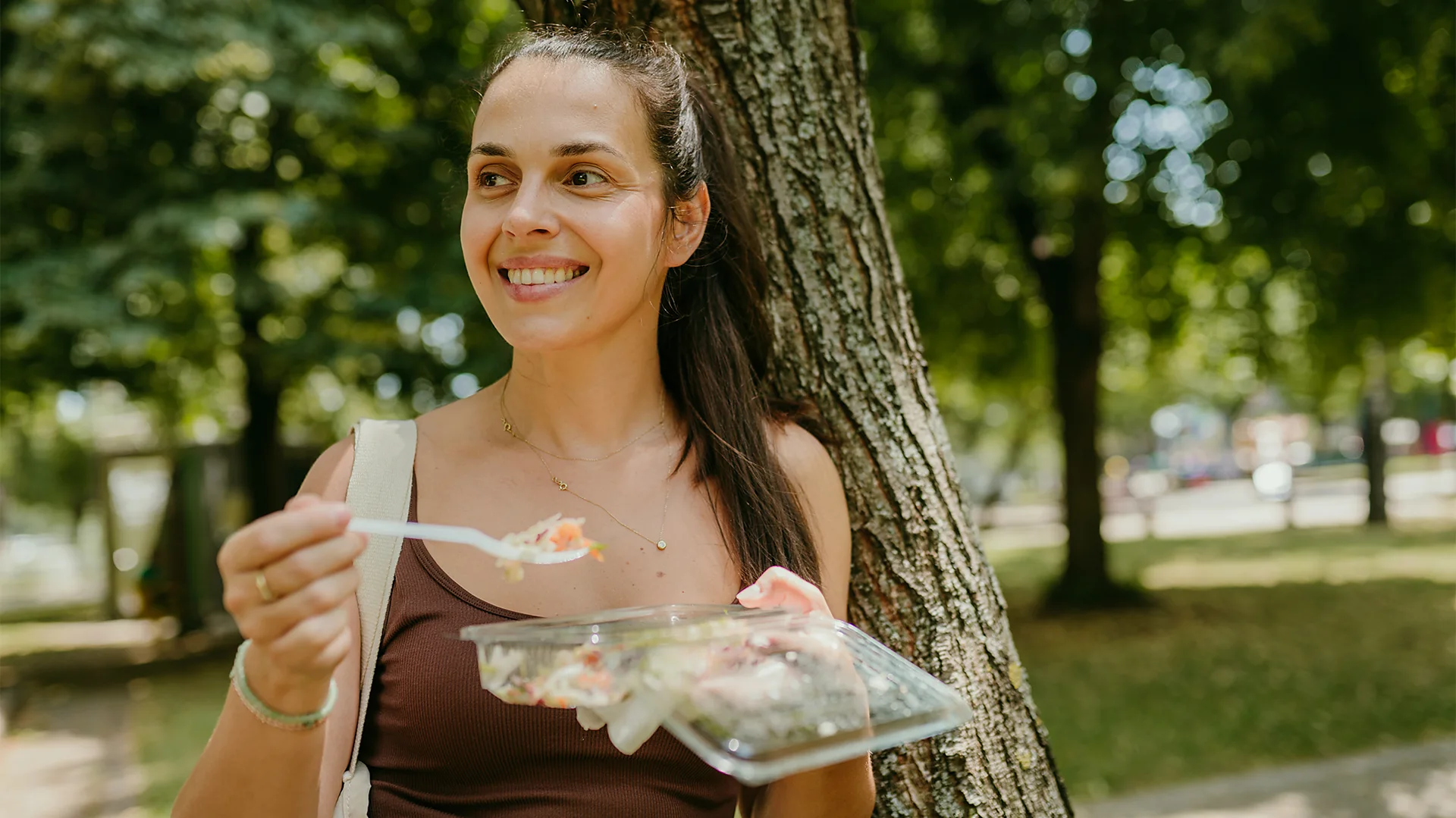 Getty Images A woman eats a healthy lunch outside (Credit: Getty Images)