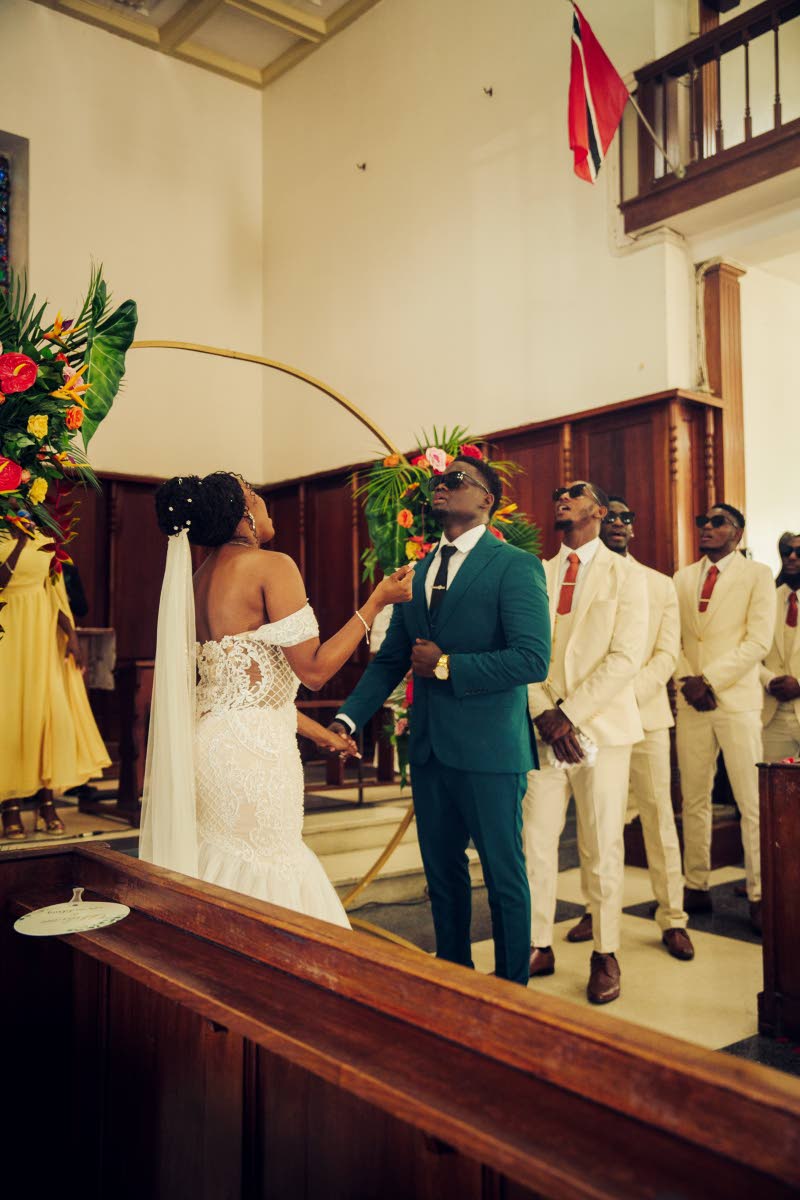 With God at the foundation of their relationship, the newly-weds take a moment to praise Him during a worship segment of their ceremony.